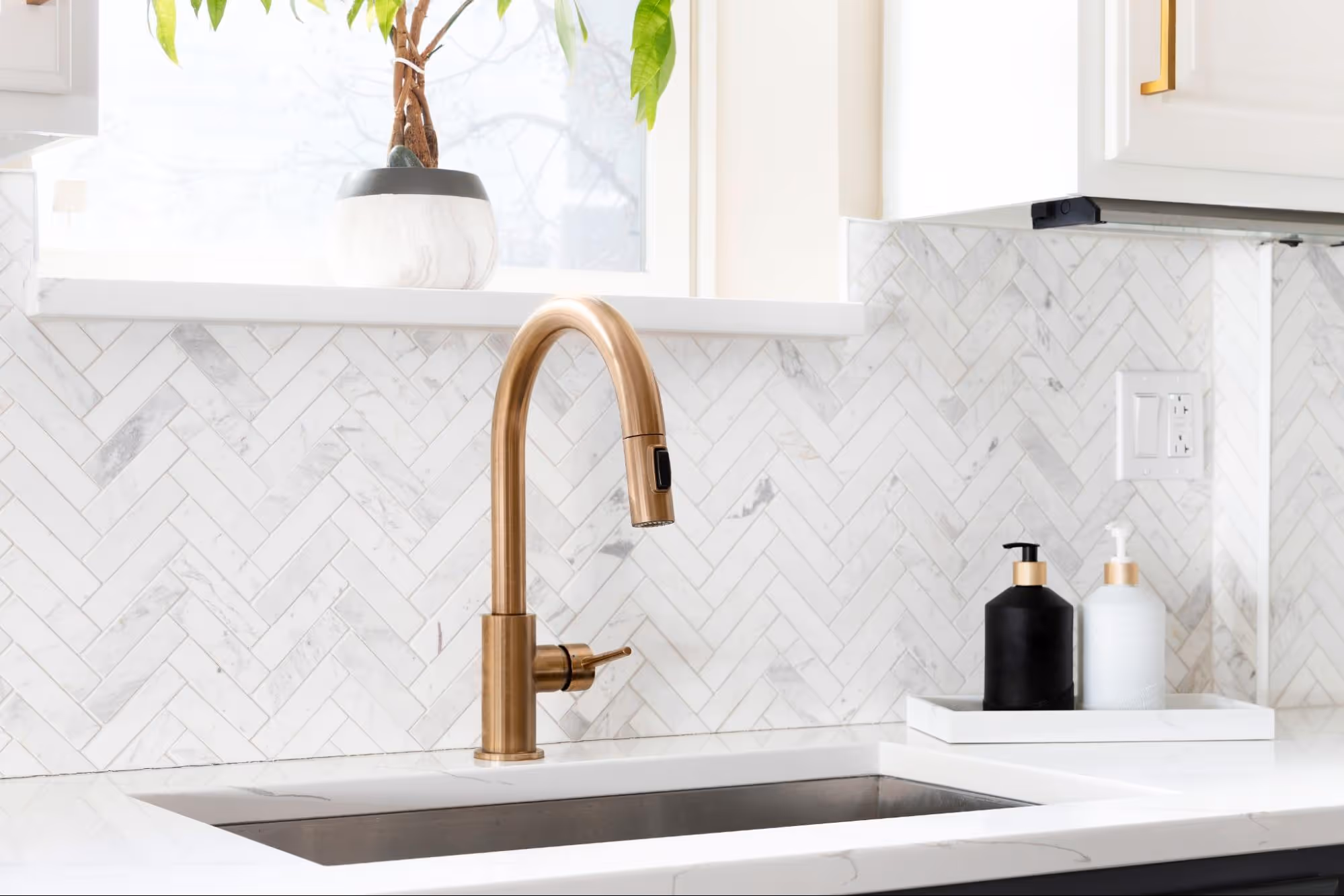 Bright modern kitchen featuring contemporary backsplash tile, sleek countertops, natural light, and clean finishes designed for a refined residential interior.