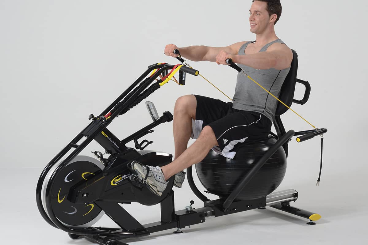 Male on BallBike performing core, cardio, and strength workout