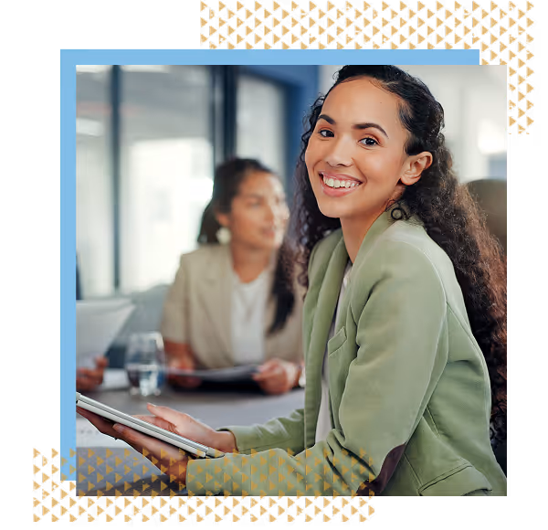 a happy young accountant smiling for the camera while seated at a meeting