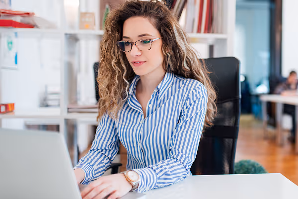accountant working on a laptop in an open office space