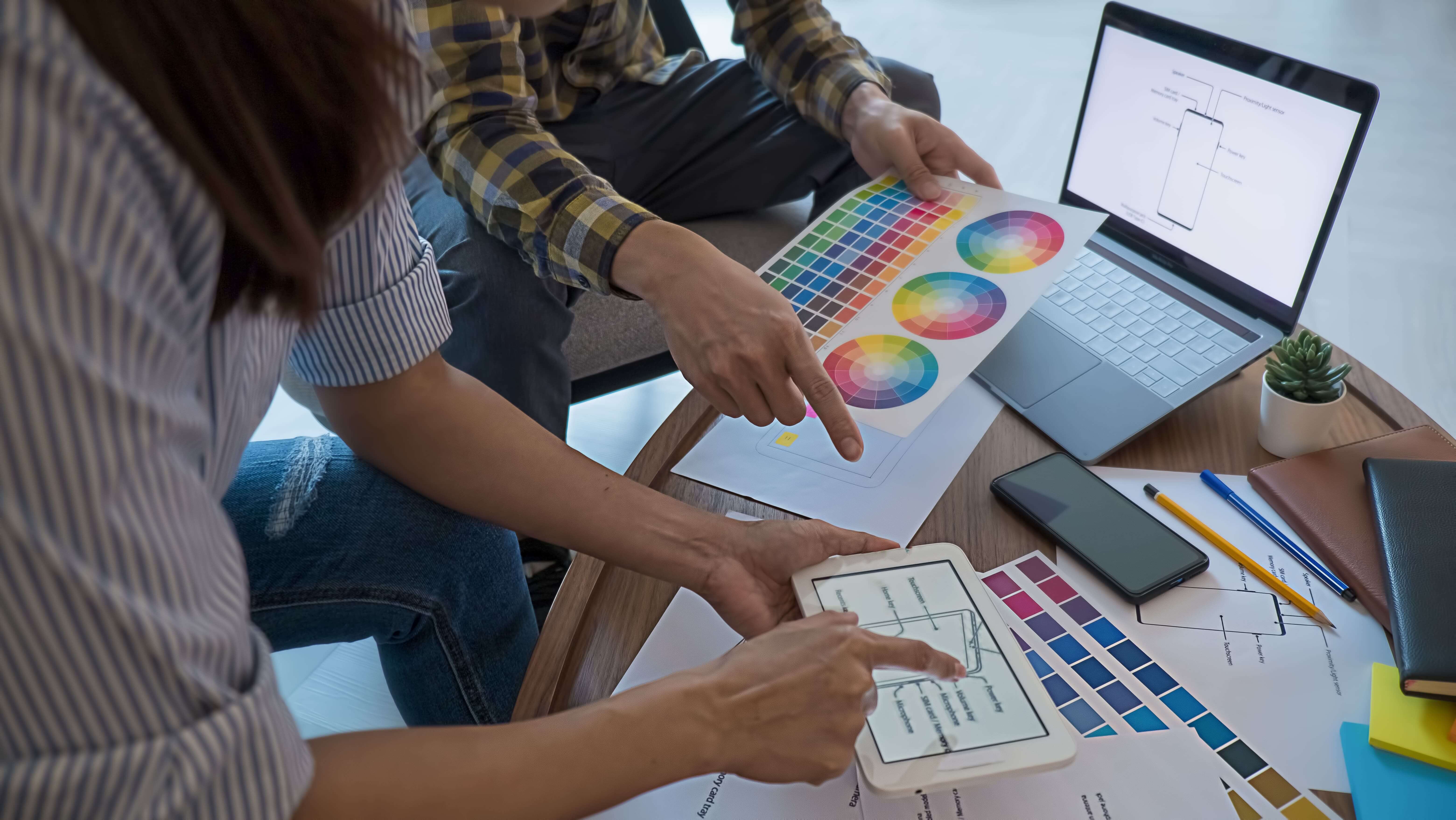 Designers reviewing color palettes and swatches in a collaborative session