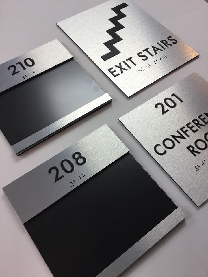 Custom brushed aluminum ADA room signs with braille for offices, conference room, and exit stairs