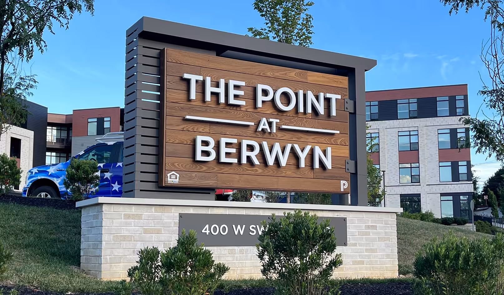 Outdoor monument sign made of stone and brick with business name