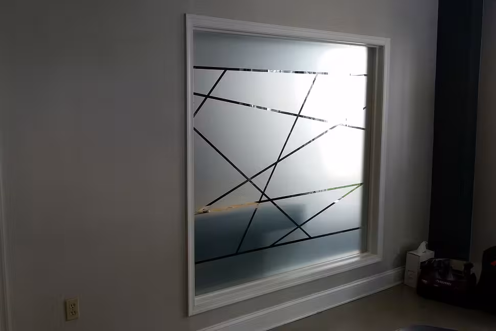 Interior glass window with frosted privacy film and diagonal clear line pattern.