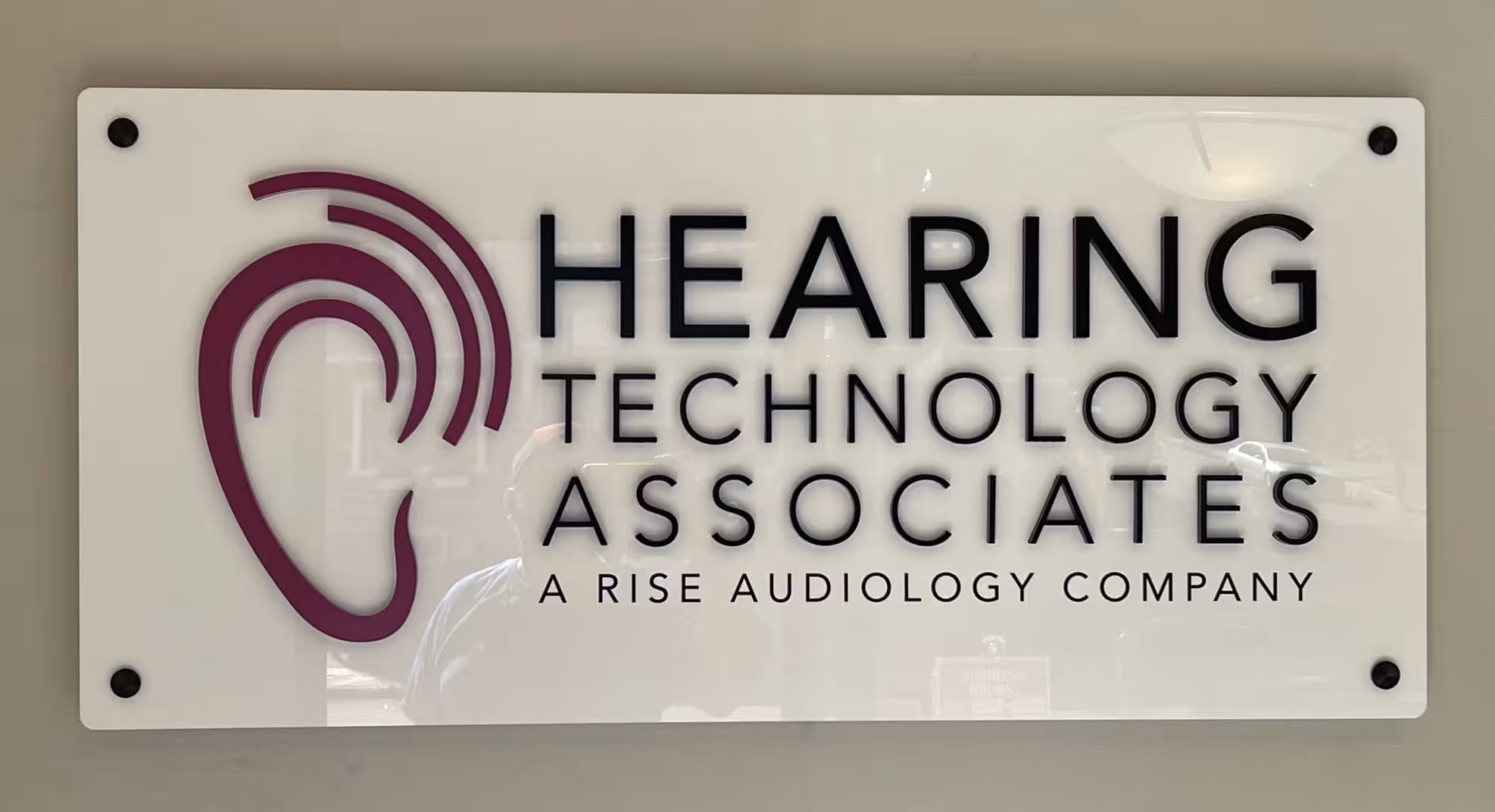 Branded acrylic office panel sign with company logo.