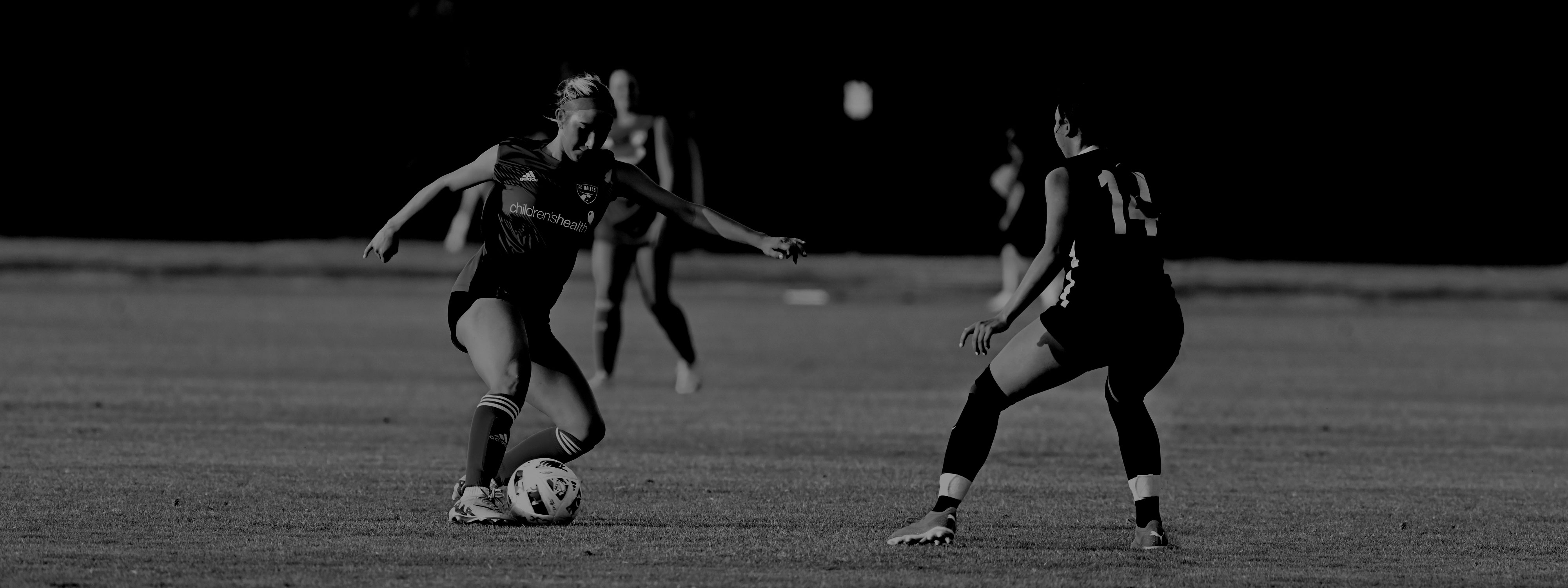 Player dribbling past defender.