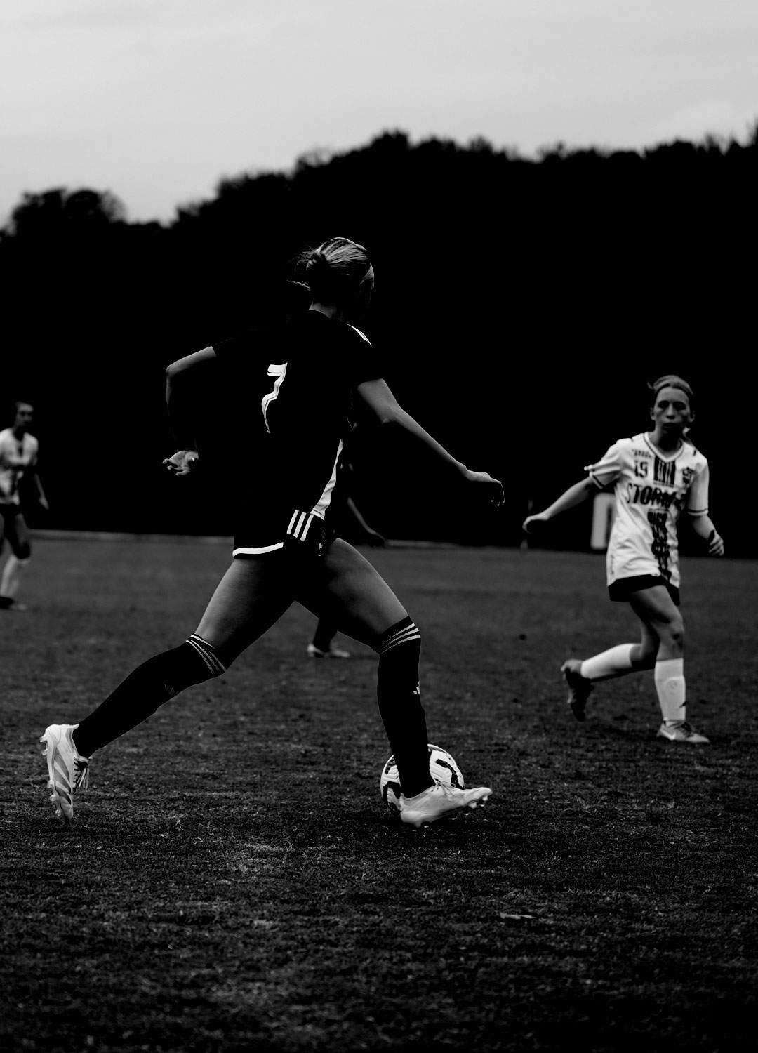 Soccer player using change of speed on defender.