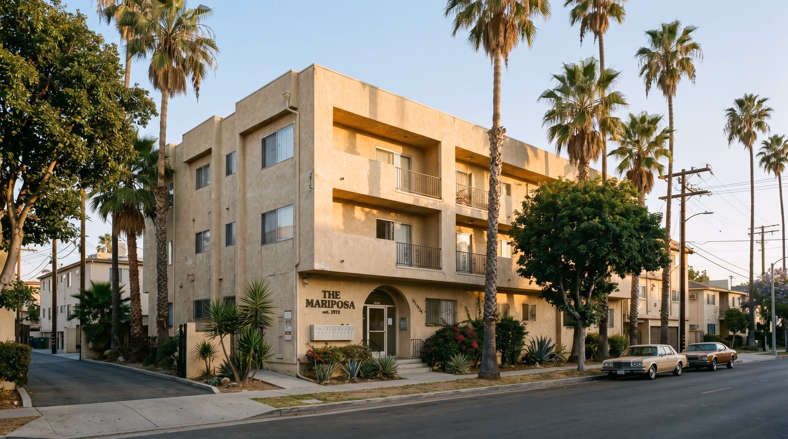 Classic 1970s stucco multifamily apartment building in Los Angeles at golden hour with palm trees, representing rental revenue optimization