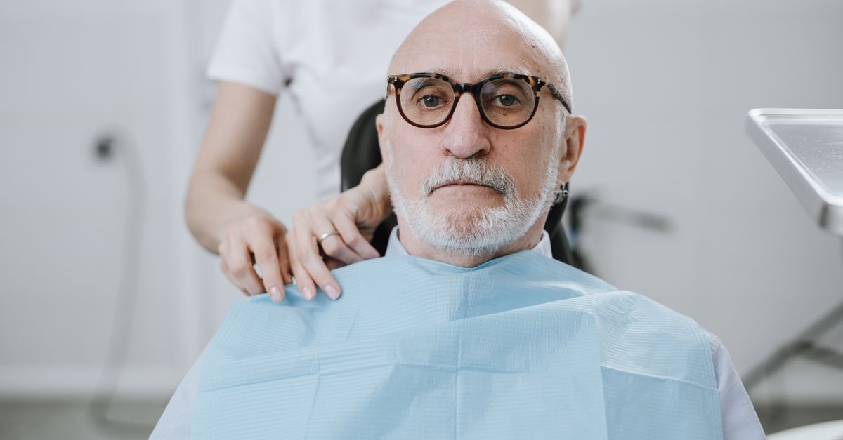 Older man in a dental chair during an appointment with his dentist