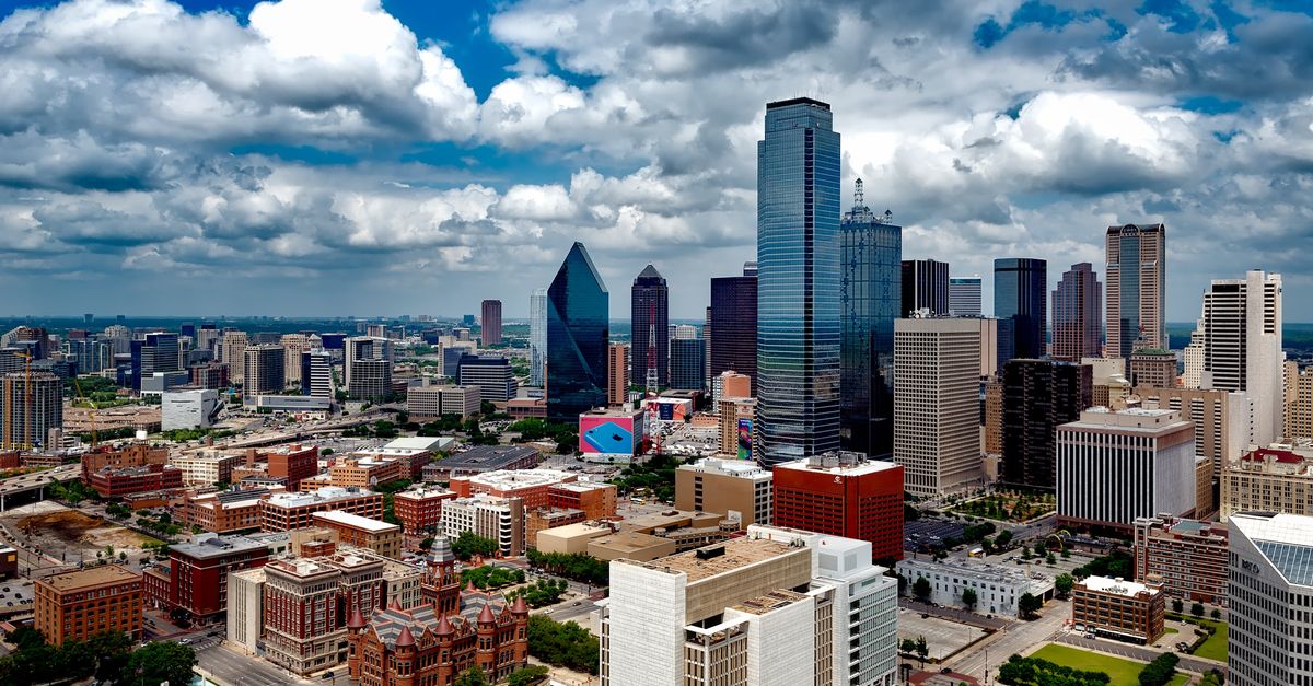Dallas skyline under a cloudy sky, seen from above the city