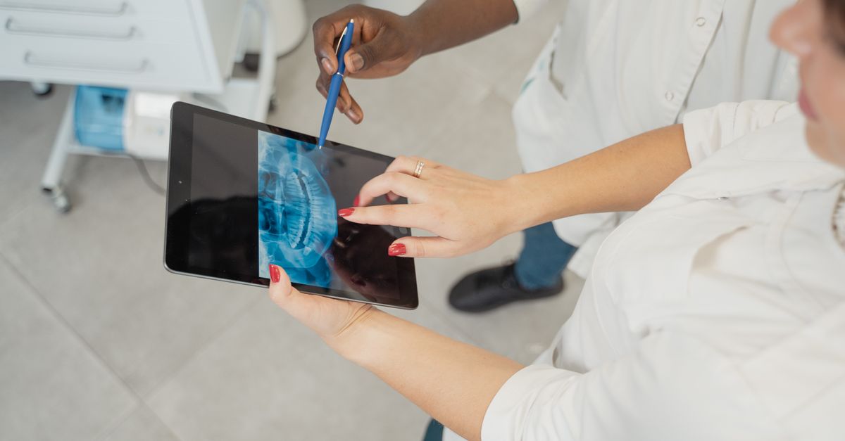 Dentist and patient looking at a dental scan on a tablet