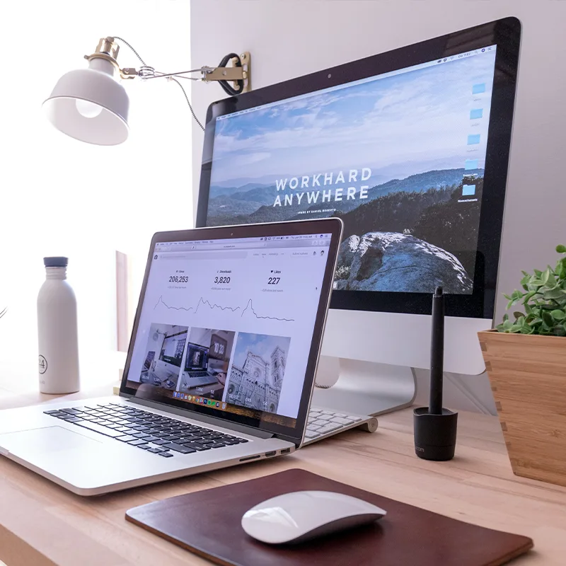 Desktop workspace setup with monitor, tablet, and coffee cup.