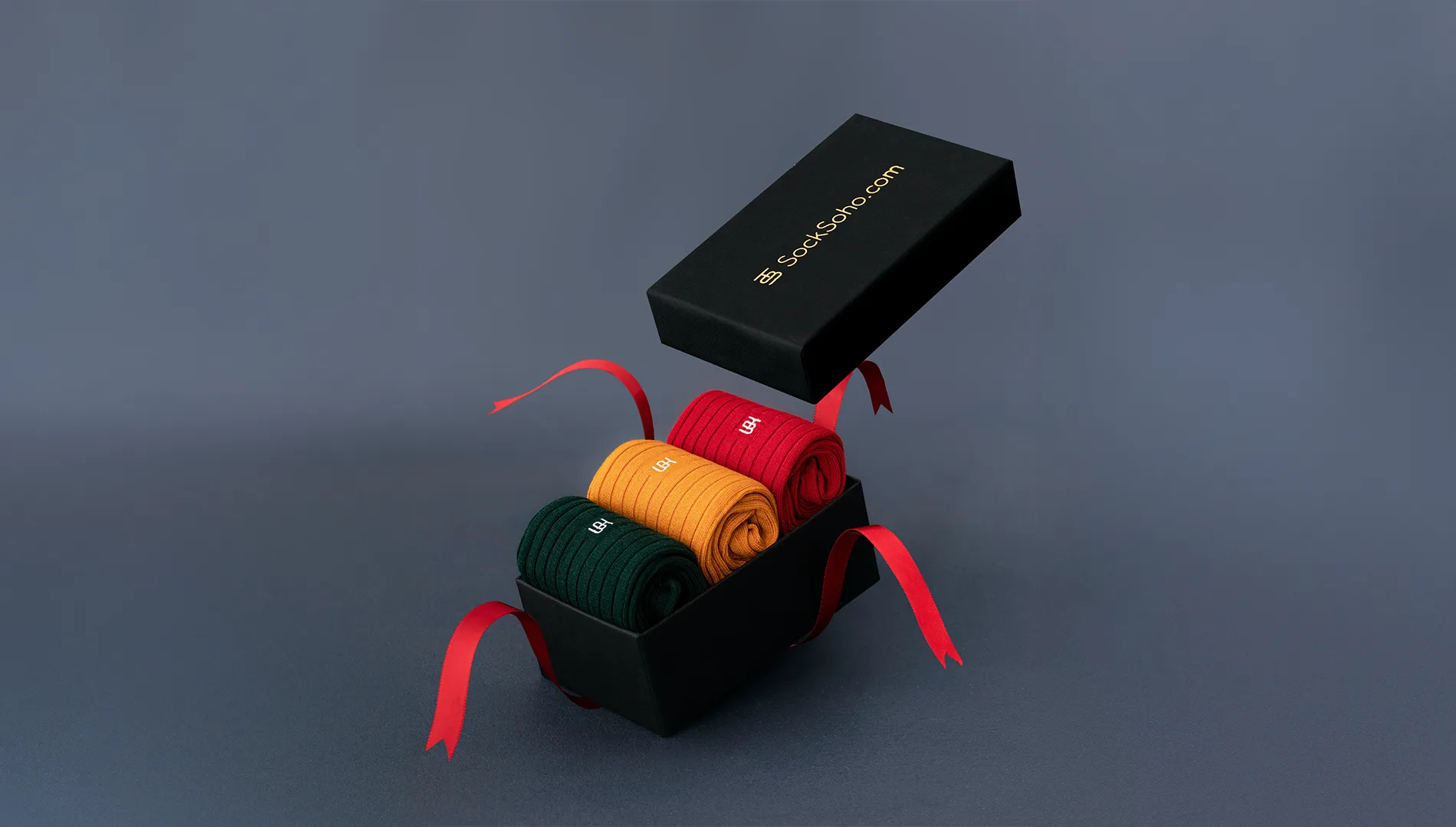 Box of socks against gray background.