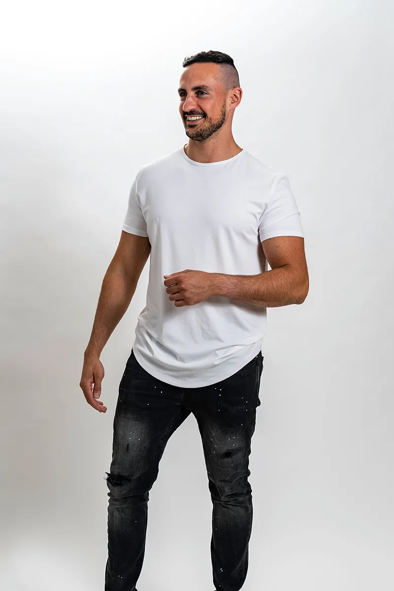Full-body portrait of a man in white t-shirt and black pants standing confidently.