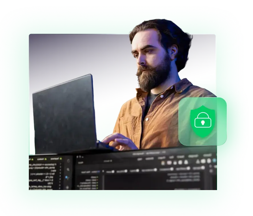 Bearded man in a brown shirt working on a laptop with code on the screen and a green security lock icon overlay.