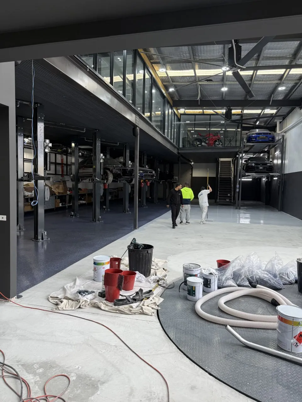 Remote-controlled concrete grinder preparing a large commercial floor in Sydney