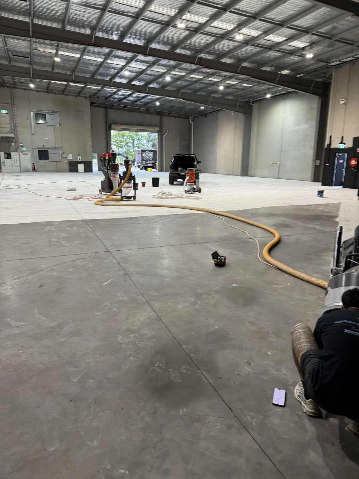 Commercial concrete grinding and floor preparation in a Campbelltown warehouse.