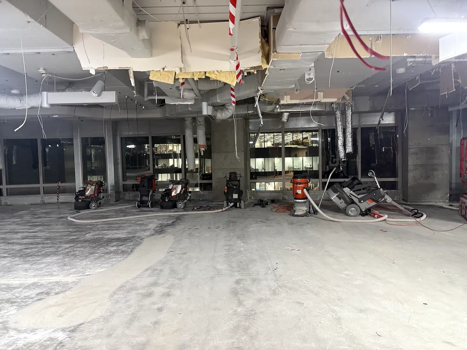 Commercial concrete grinding equipment operating across a large Sydney floor