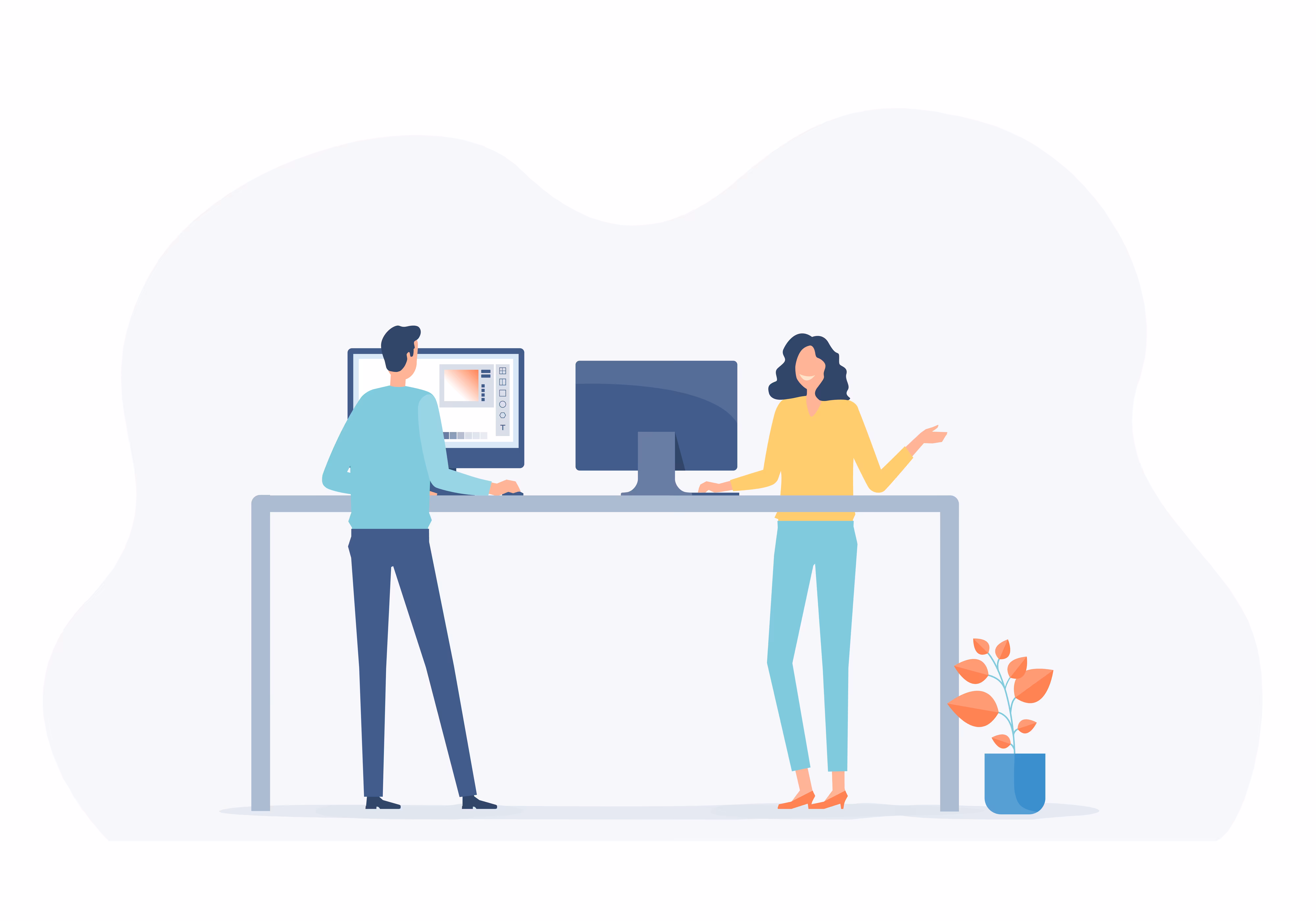 Zwei Personen stehen an einem hohen Tisch mit zwei Computermonitoren, daneben ein Topfpflanze mit orangen Blättern.