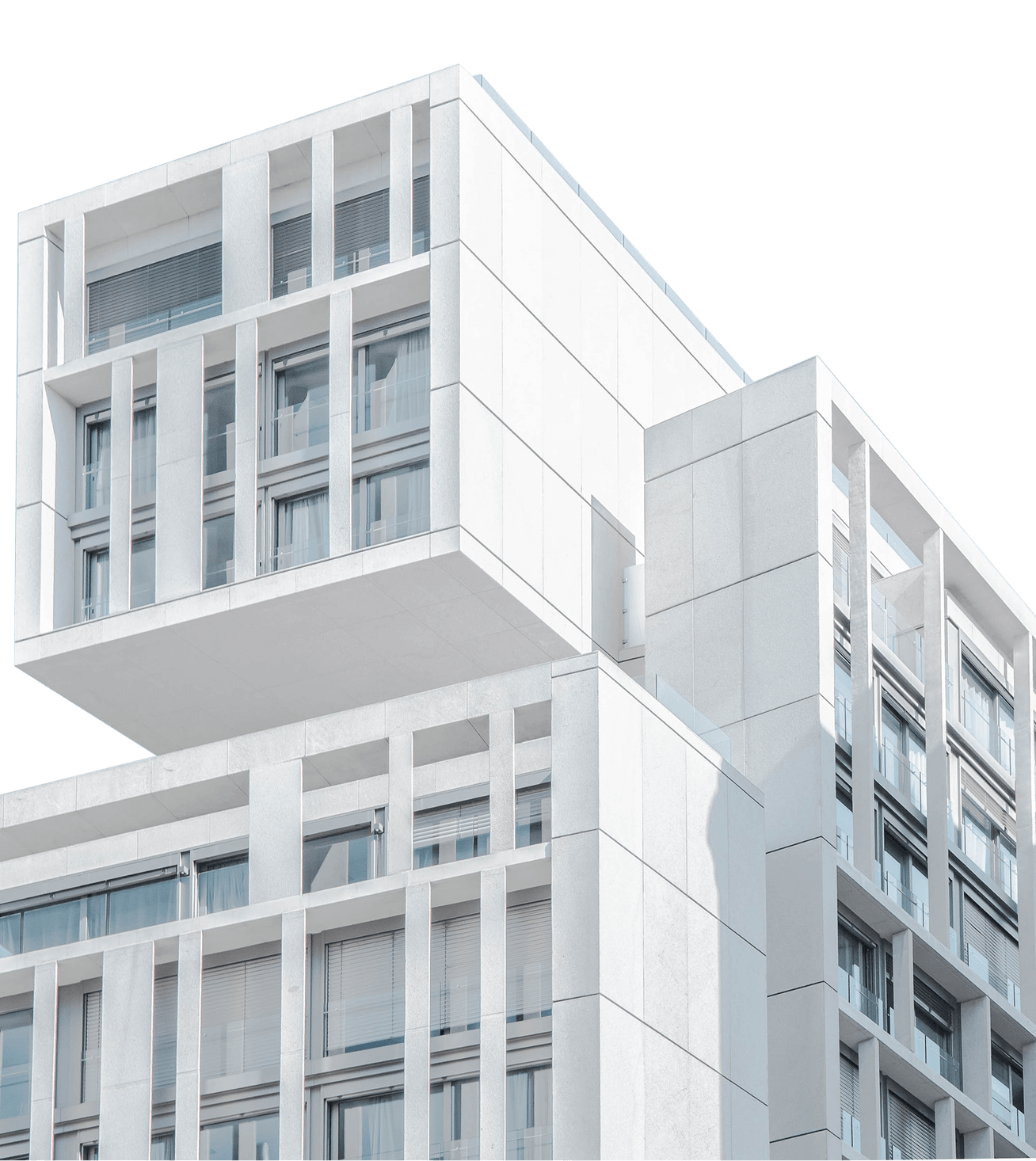 Modern white building with large windows and cantilevered upper section.