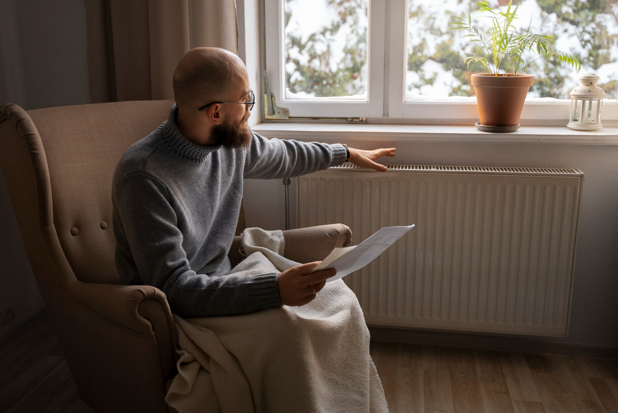 Homeowner checking a heating radiator for comfort