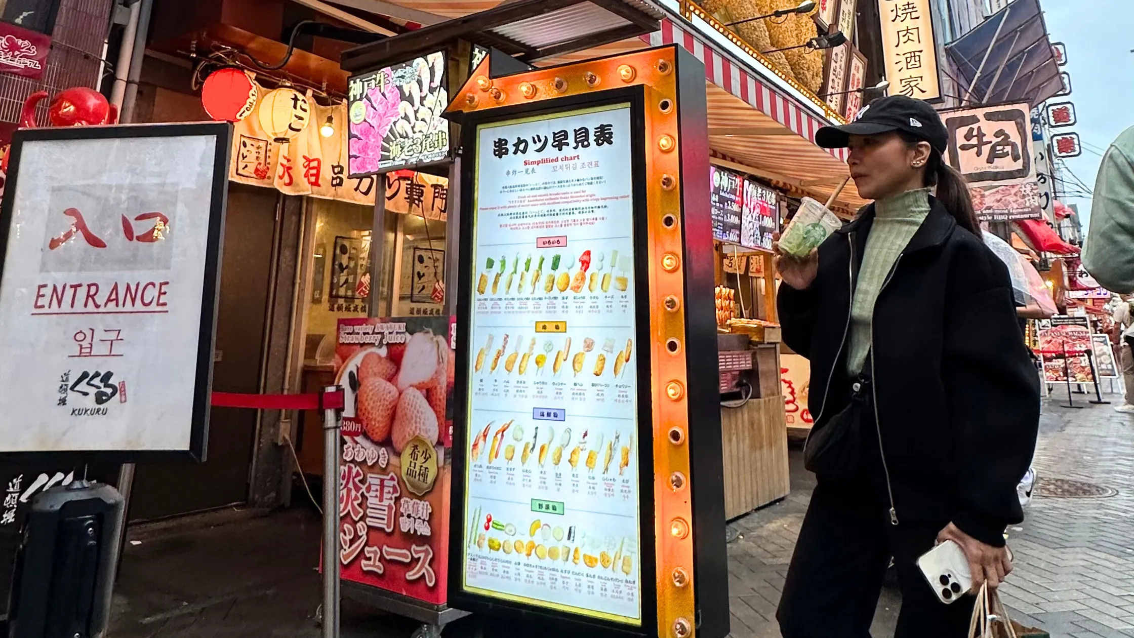Traveler enjoying a matcha drink at Dotonbori in Osaka, Japan.