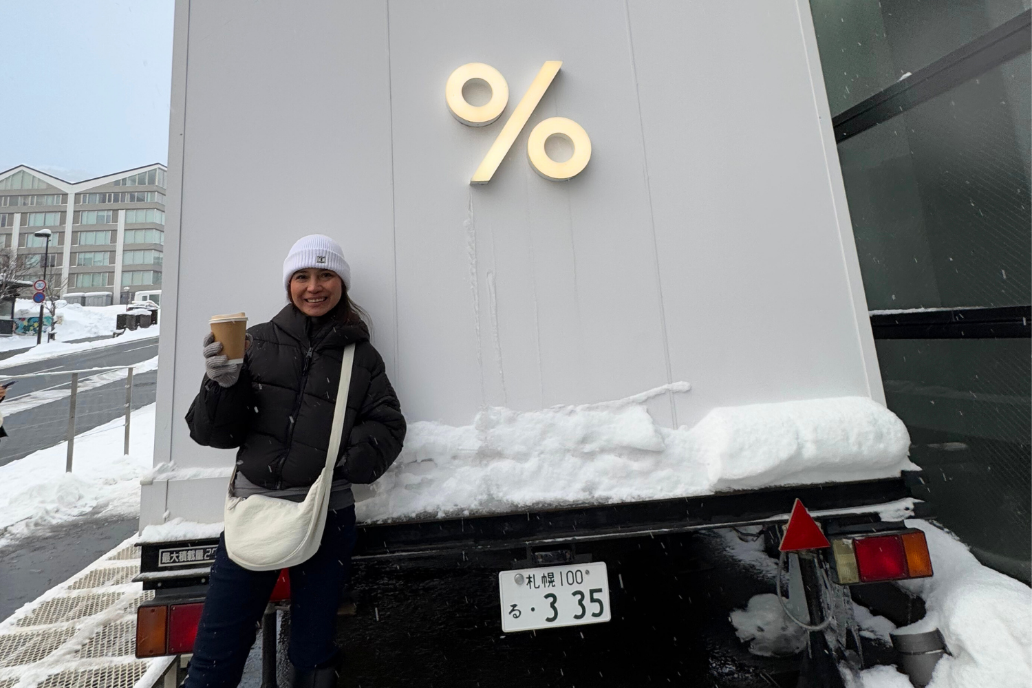 Woman holding a cup of coffee in Arabica Niseko in winter.
