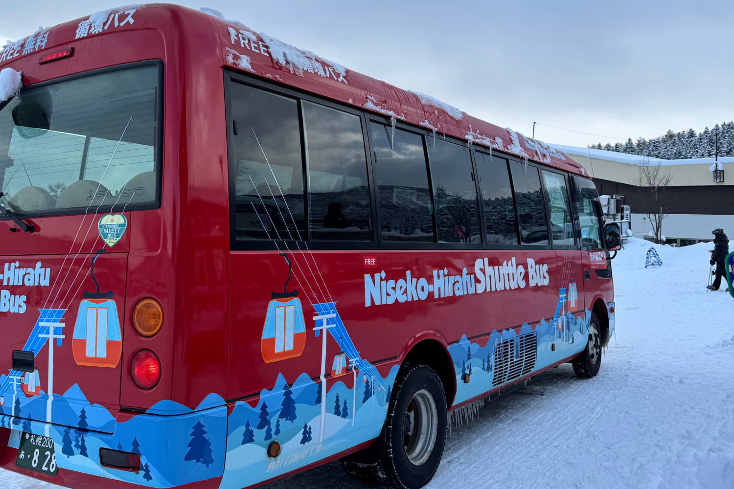 Niseko-Hirafu Shuttle Bus parked in the station on a thick snow.