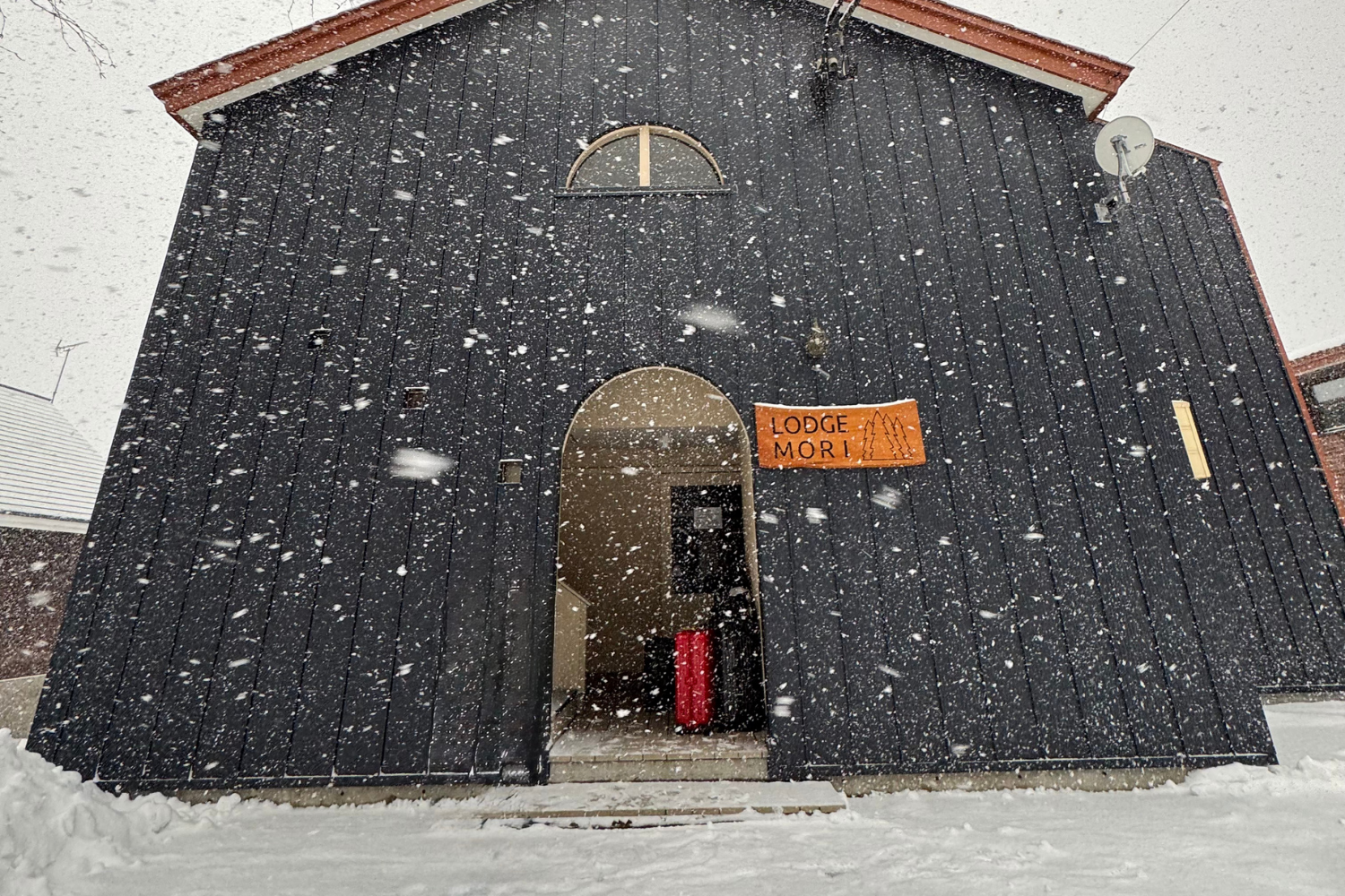AirBnB house in Niseko Village covered in thick snow.