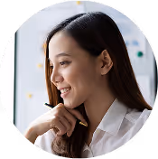 Woman in white blouse smiling and looking sideways.