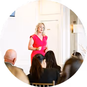Woman giving a presentation in front of audience.