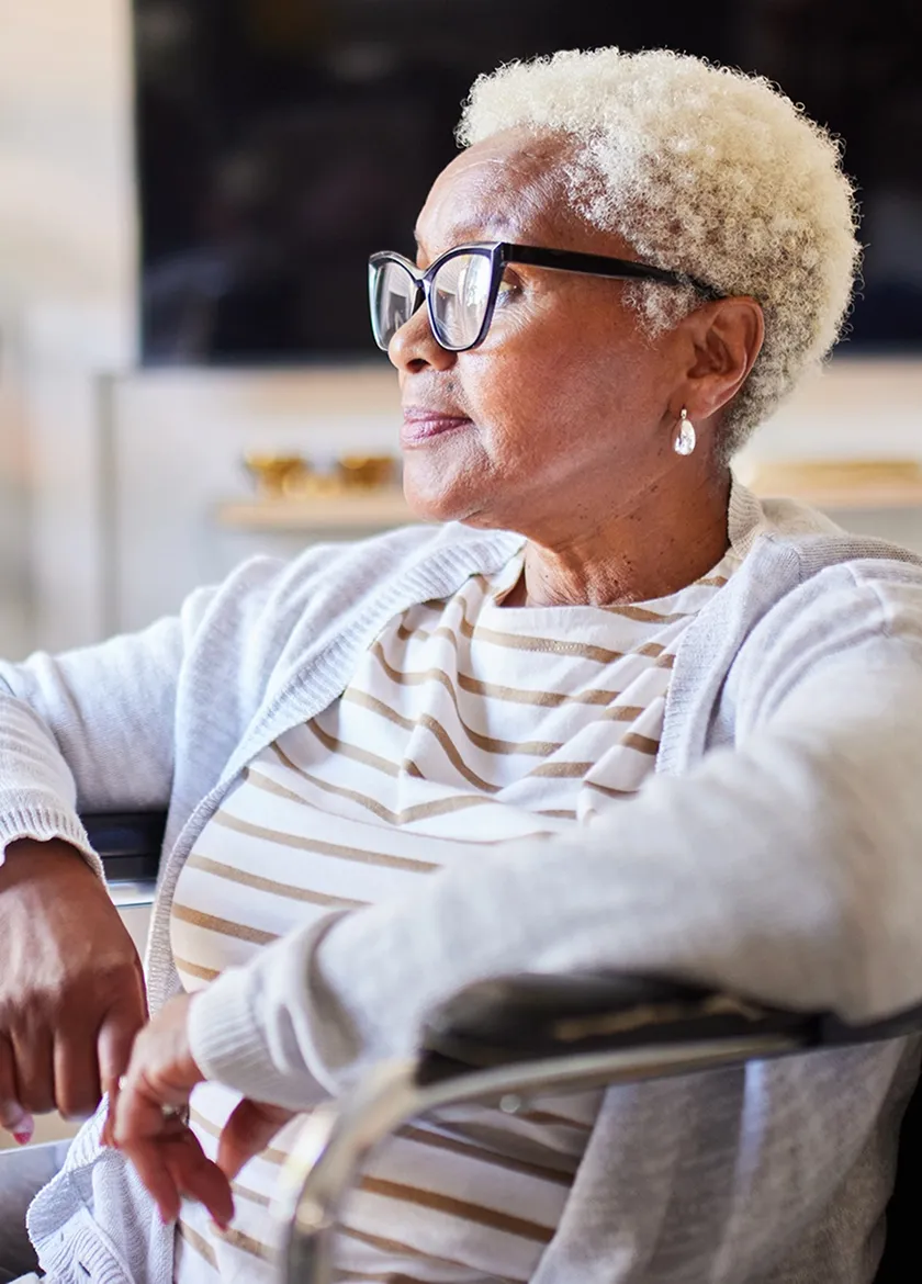 Senior woman sitting comfortably at home during medical visit.