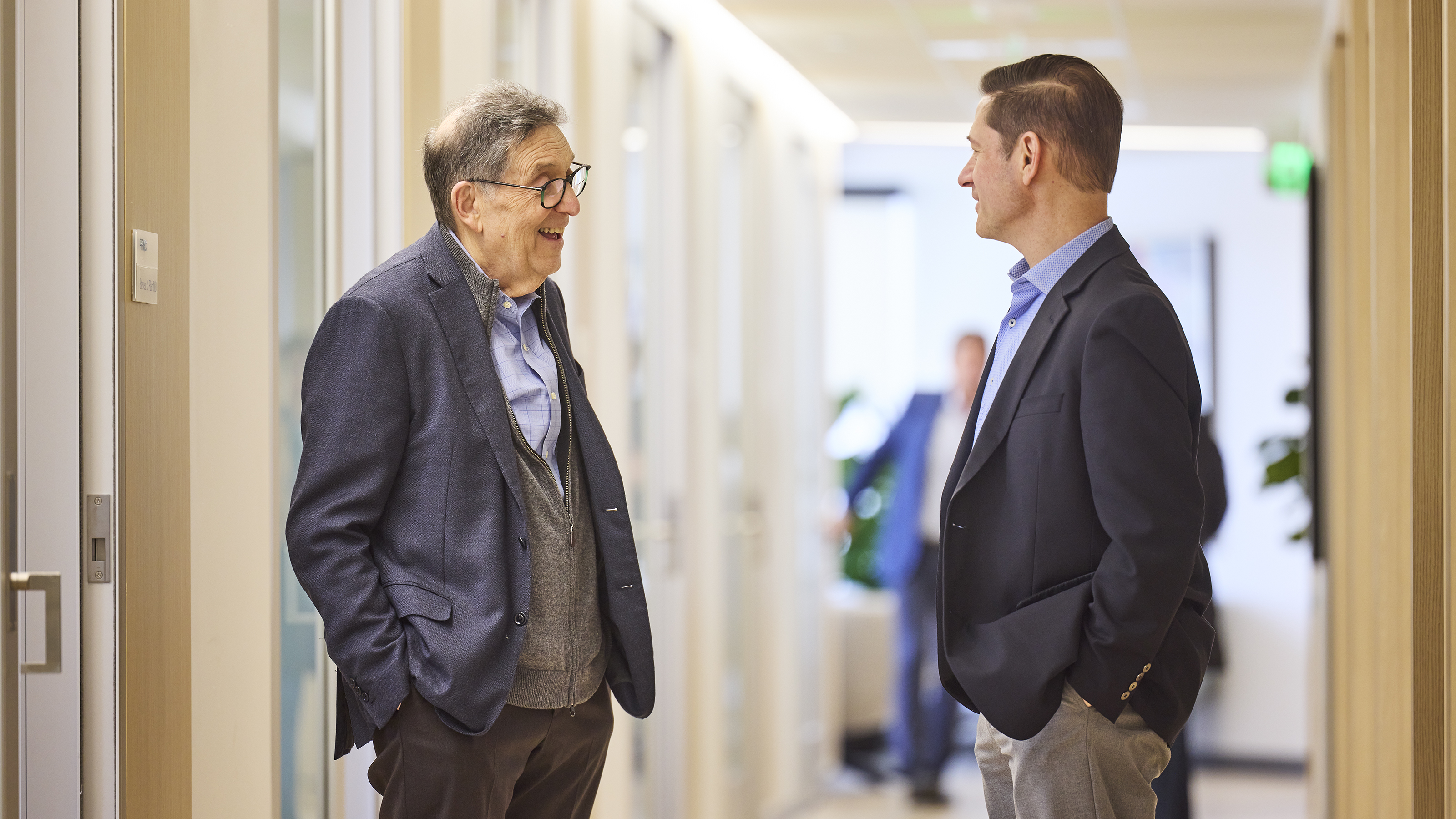 Historic photo of medical professionals in lab coats speaking at press conference.