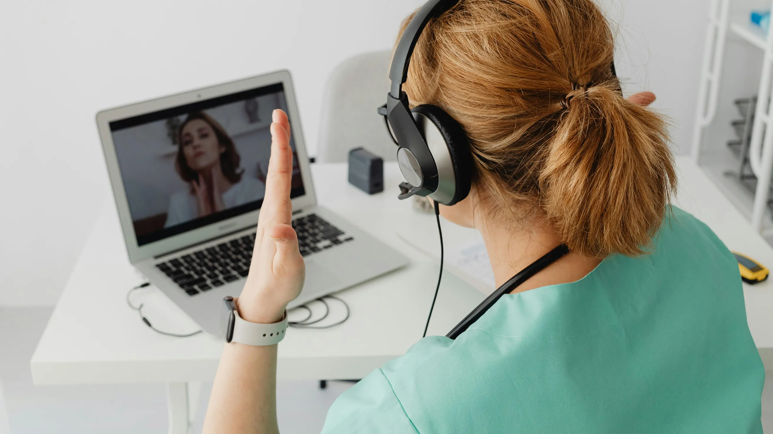 Nurse conducting telehealth visit on laptop.