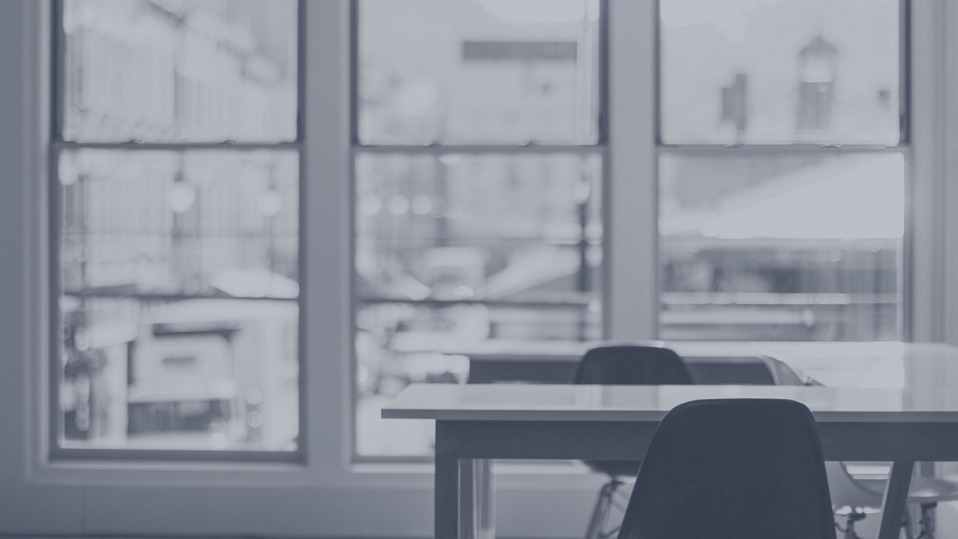 Office interior seen through a large window for a company dissolution guide