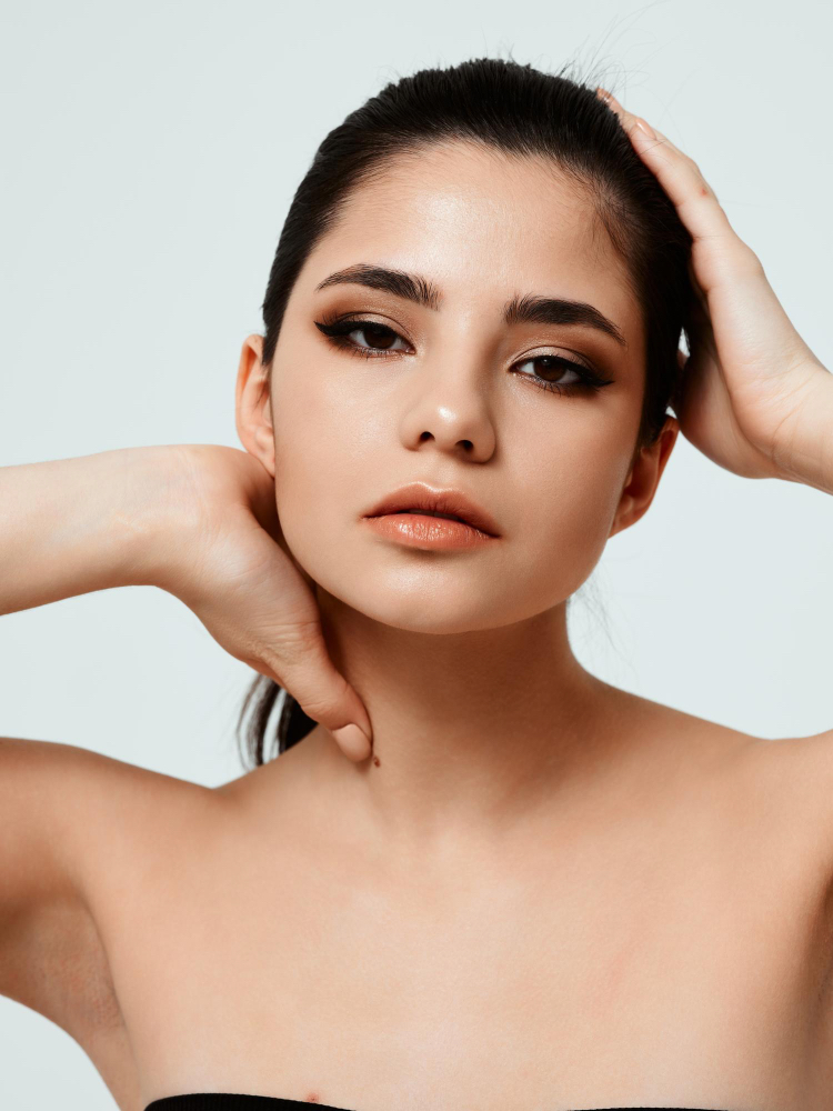 A woman touching her head and neck.