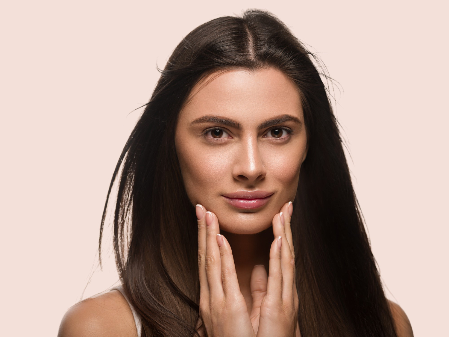 Woman touching her cheeks.