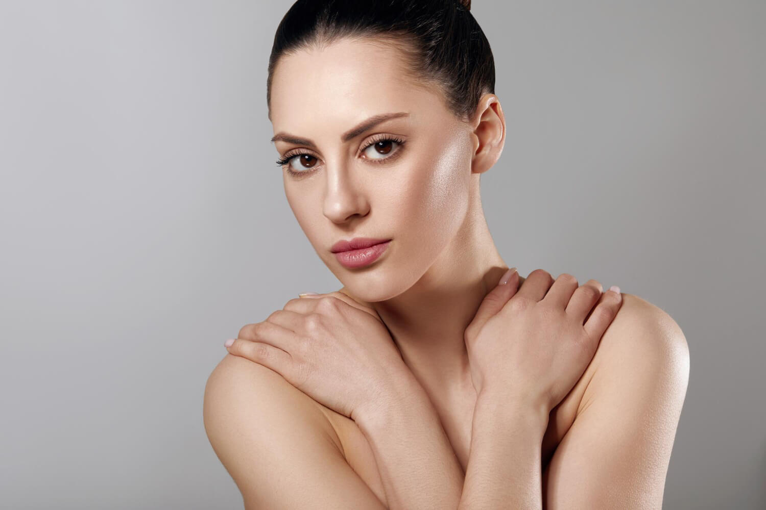 A woman hugging herself.