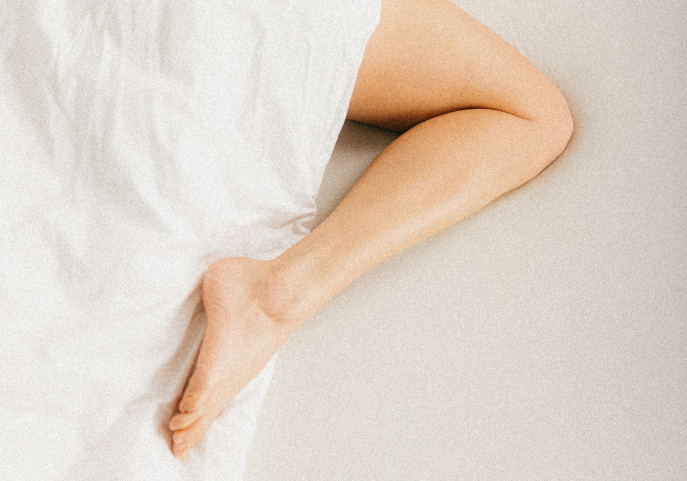 A leg covered with a blanket.