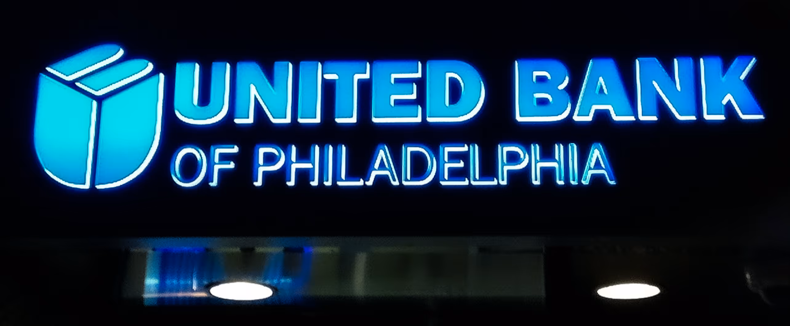 Blue channel letters mounted on top of a bank