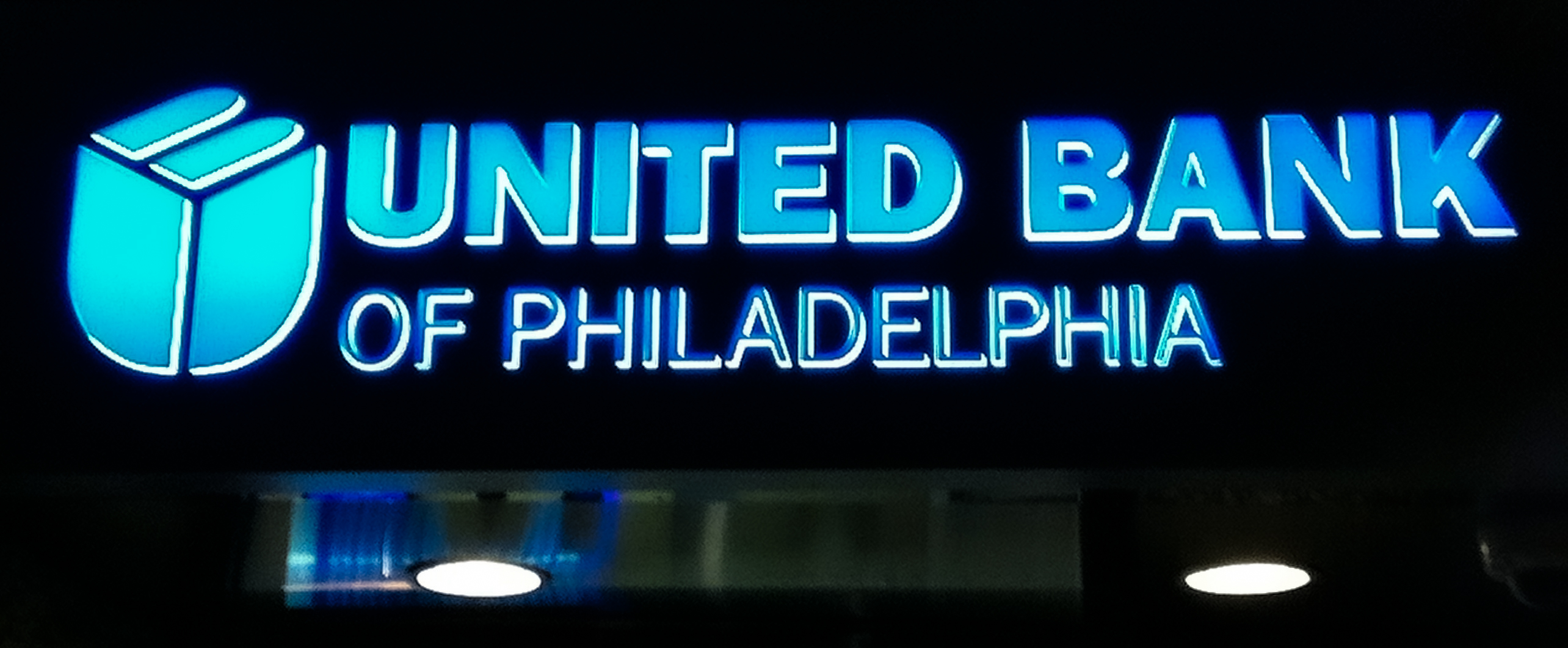 Large blue channel letters with returns lit white