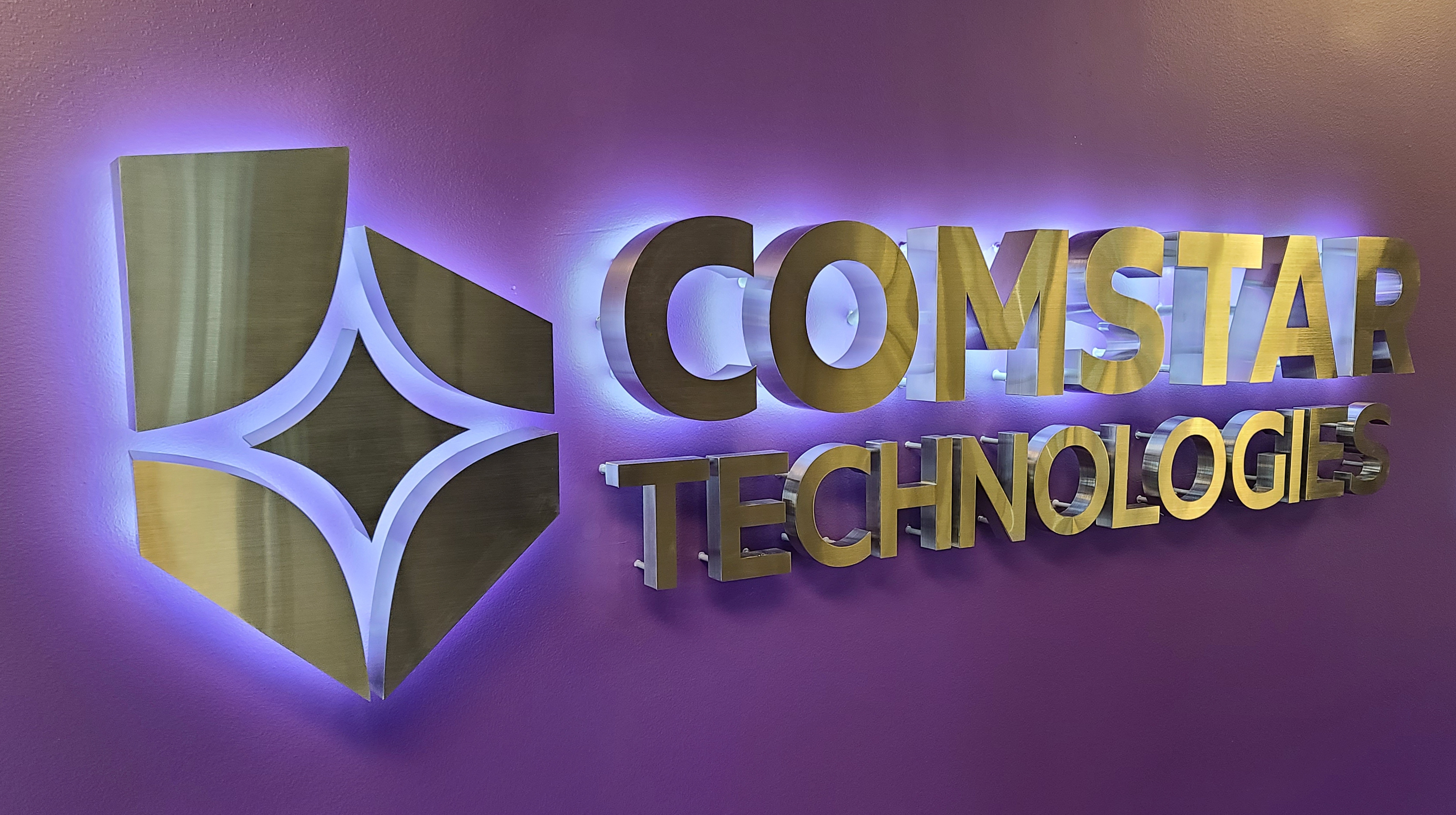 Brushed aluminum halo-lit logo and letters on an interior wall