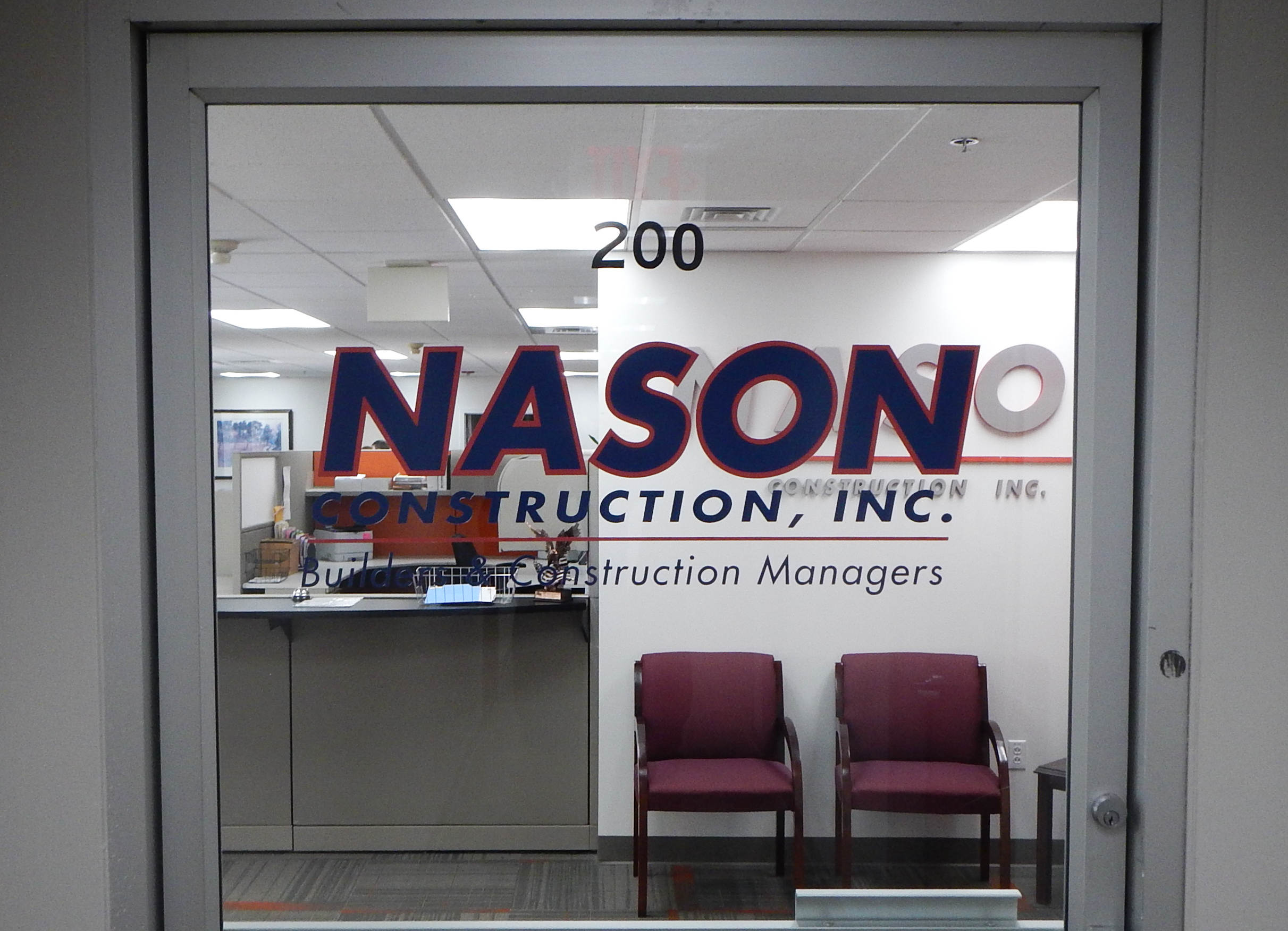 Plotted and weeded vinyl letters and logo on a glass door
