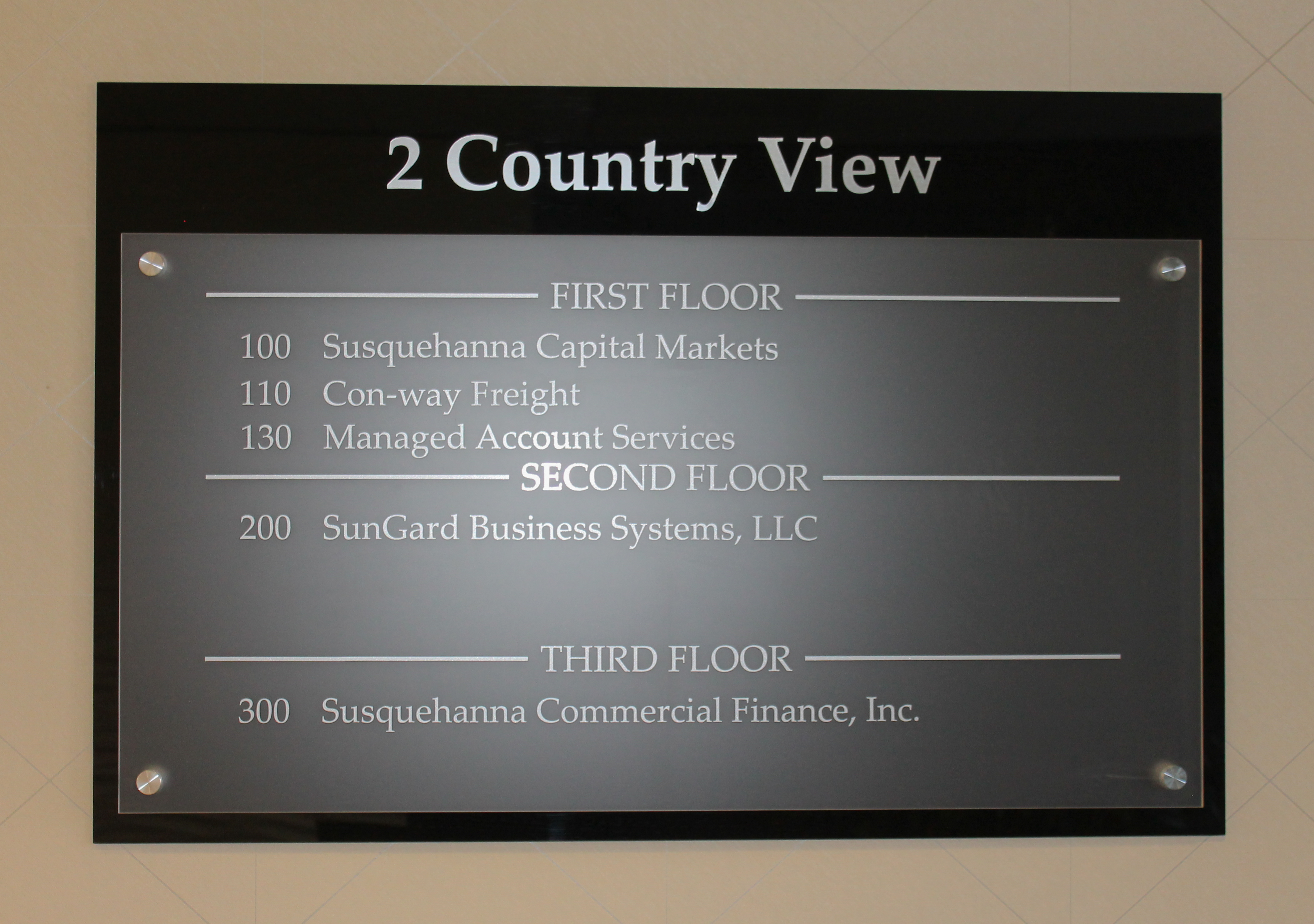 Acrylic building directory mounted on aluminum standoffs