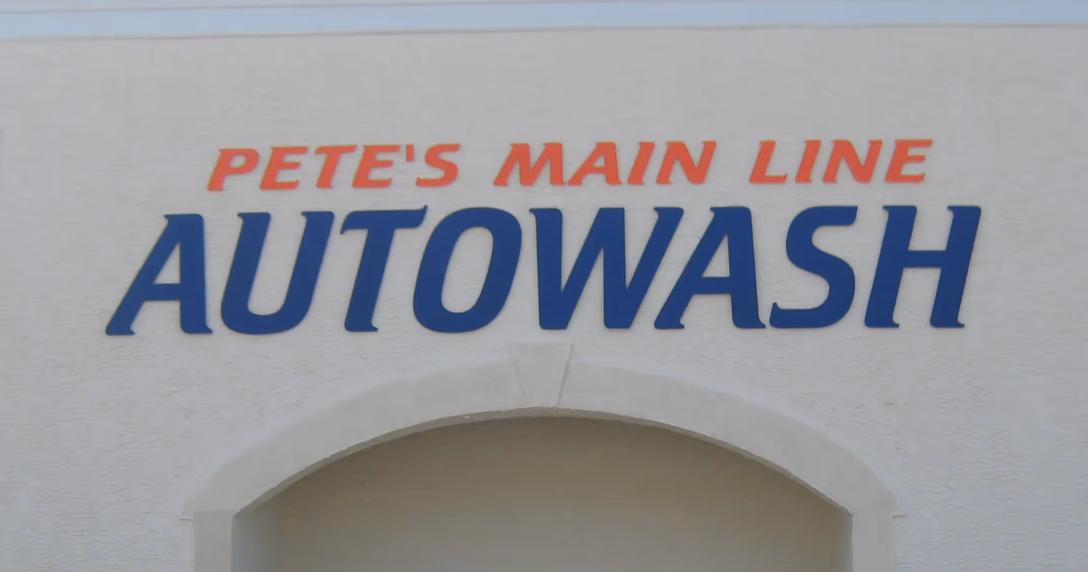 Painted acrylic dimensional letters mounted on an exterior masonry surface
