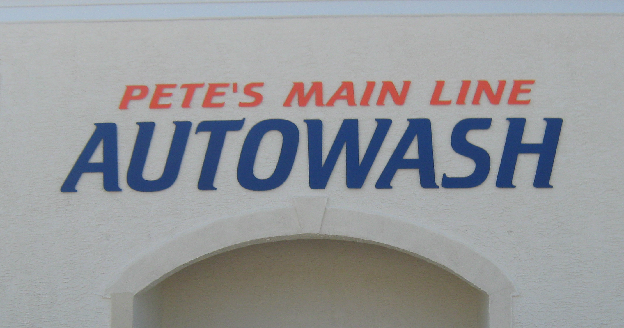 Painted acrylic dimensional letters mounted on an exterior masonry surface