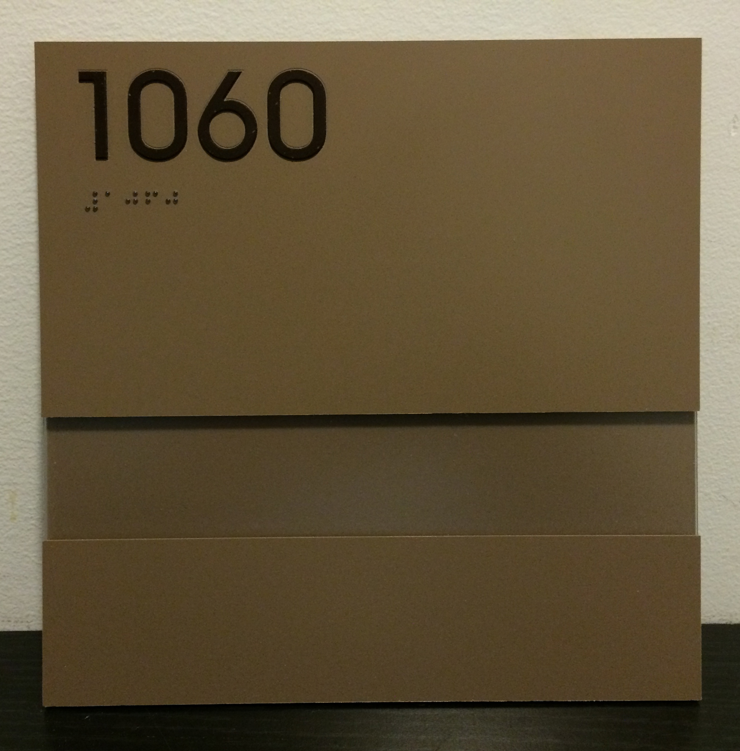 Bronze-colored, custom ADA room sign