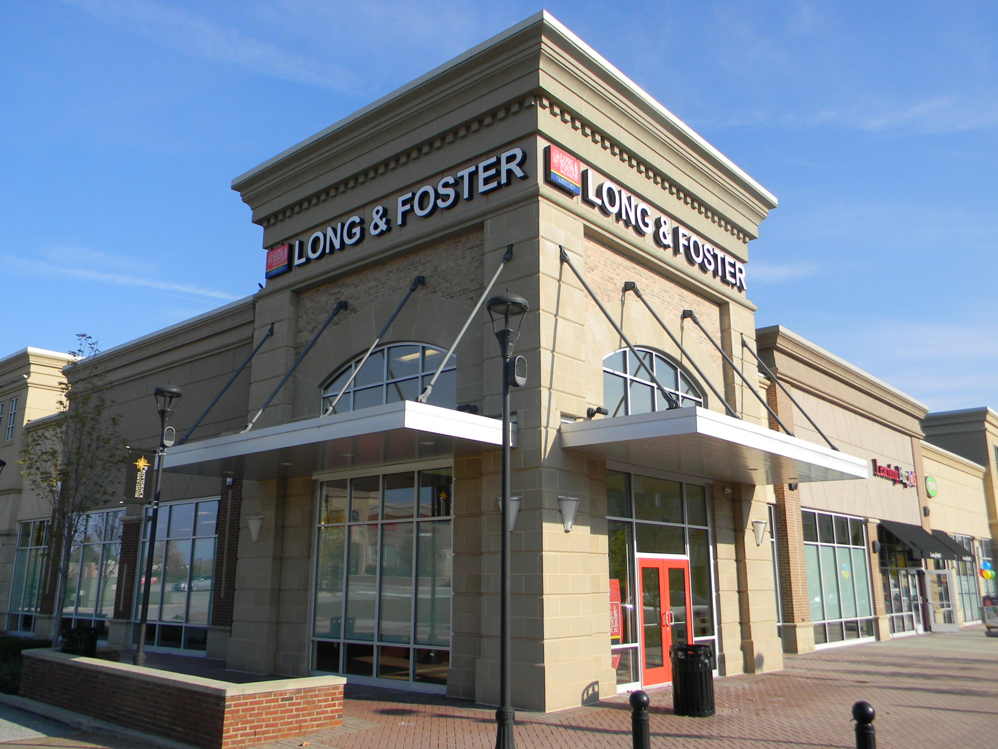 White channel letters on two sides of a corner shopping center lot