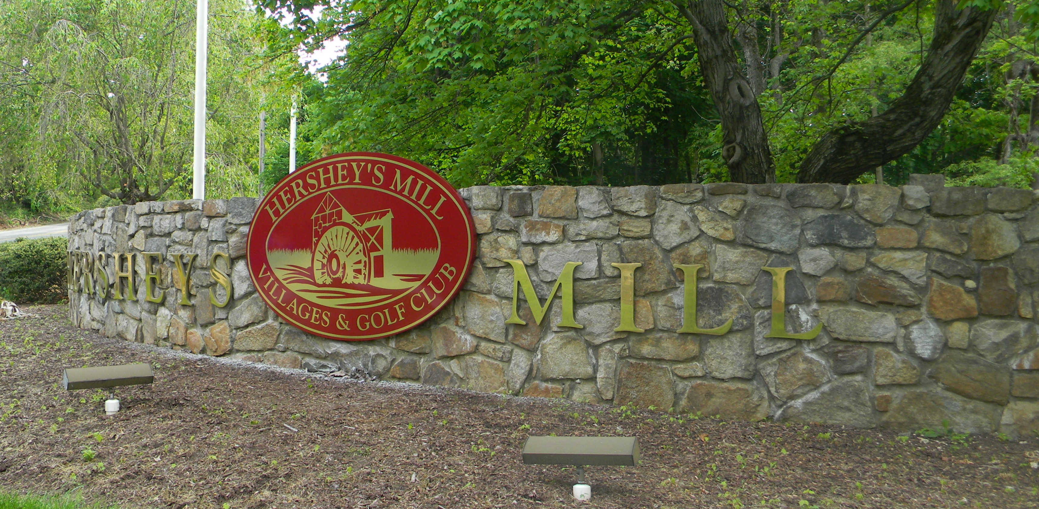 Brushed brass dimensional letters on a stone wall