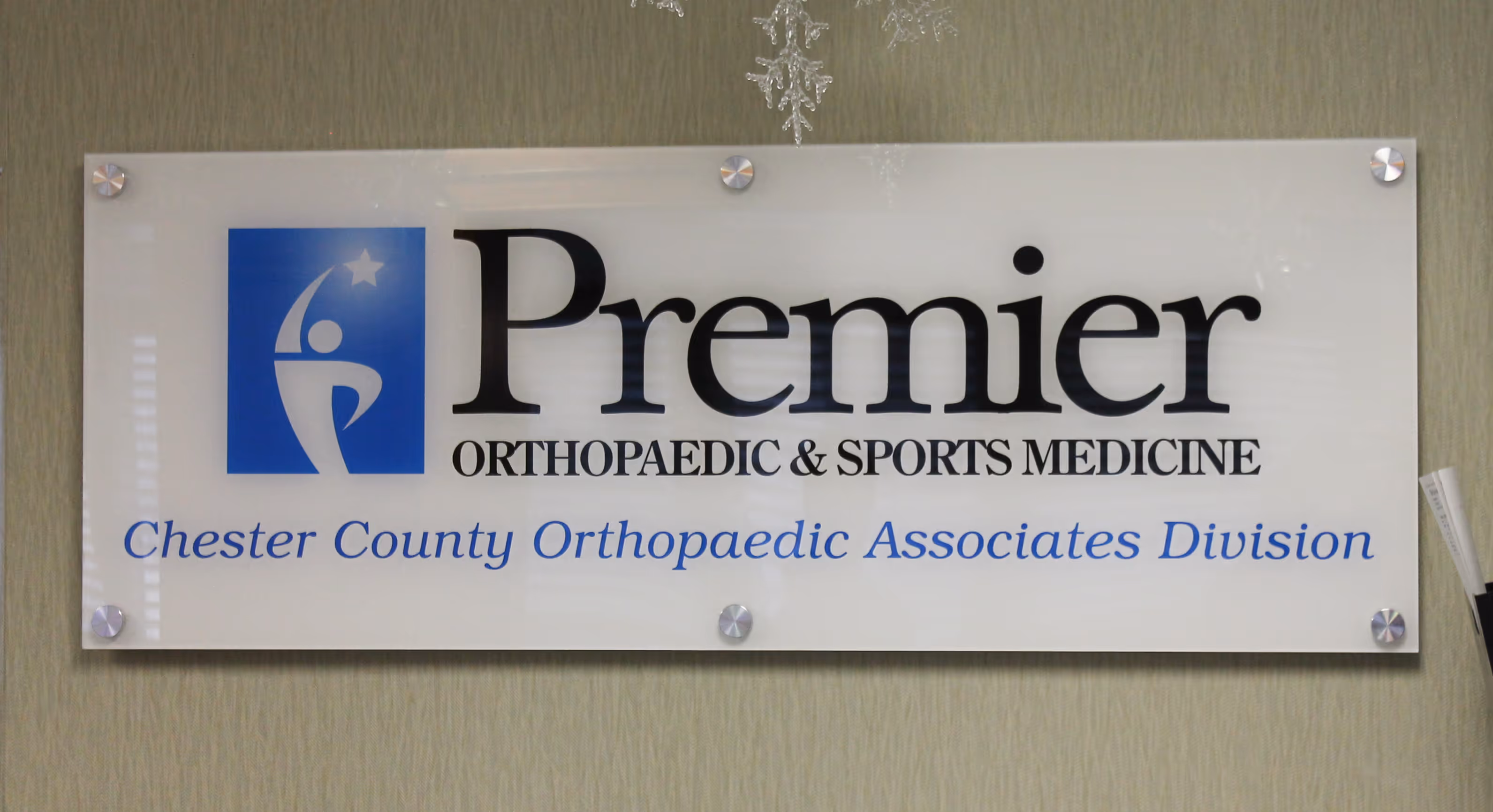 Company logo on large white acrylic panel